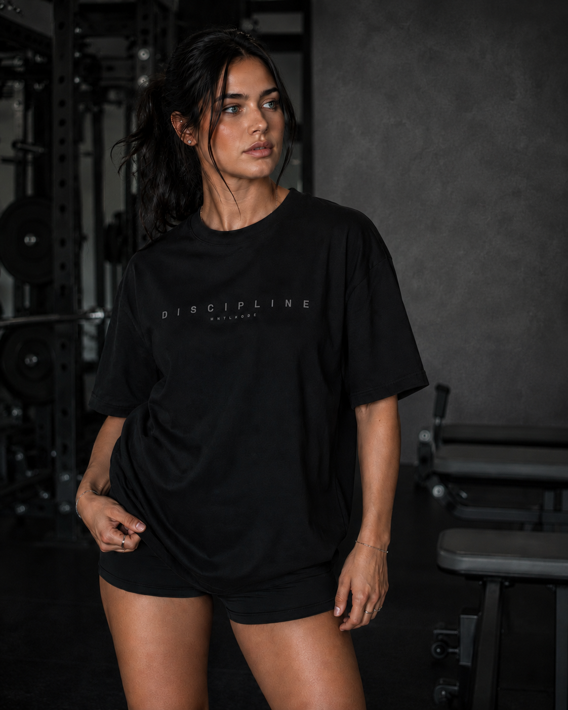fit gym Woman wearing a black t-shirt with 'Discipline' text in a gym setting